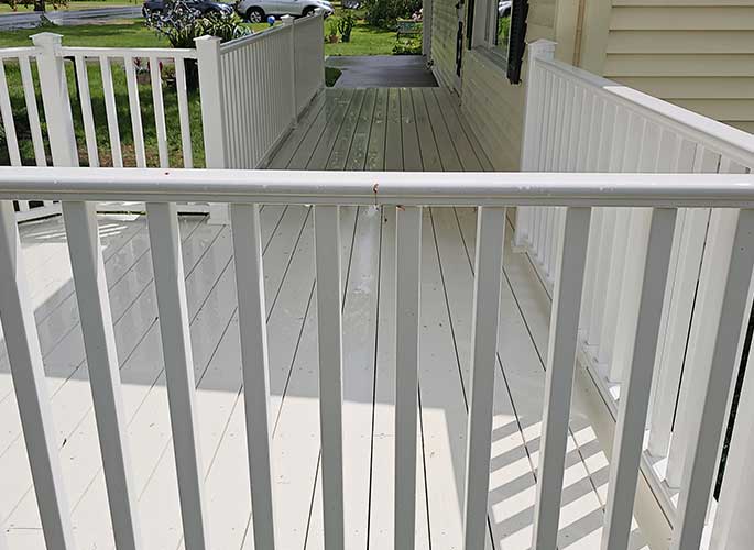 AB Powerwashing project of a white painted deck after powerwashing.